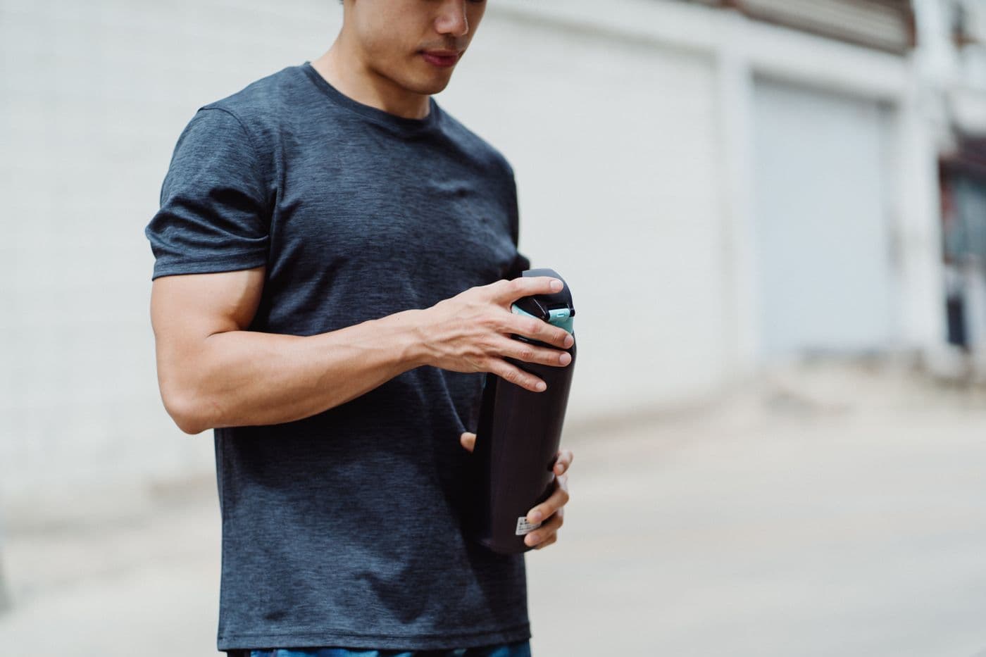 Athlete holding a water bottle outdoors